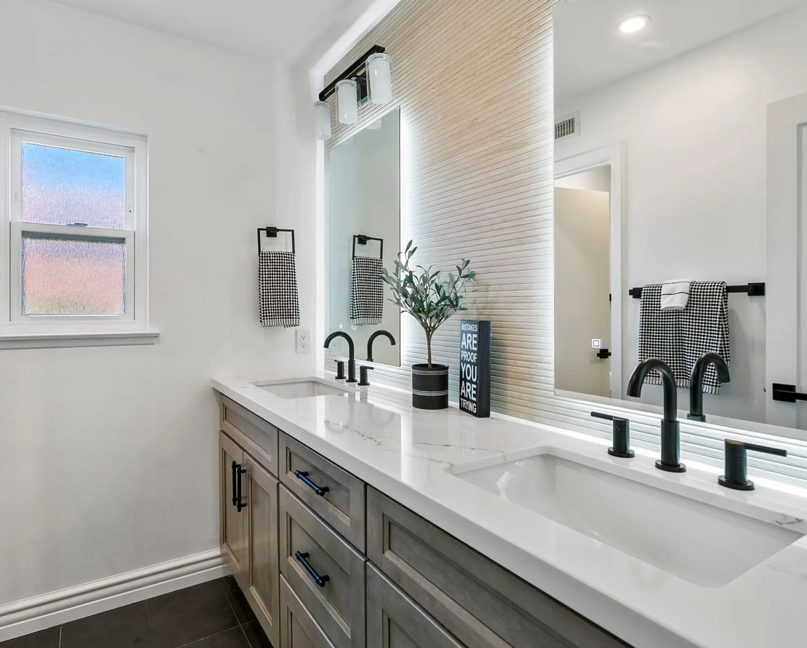 Ash / greige double-vanity bath with white quartz tops and black fixtures