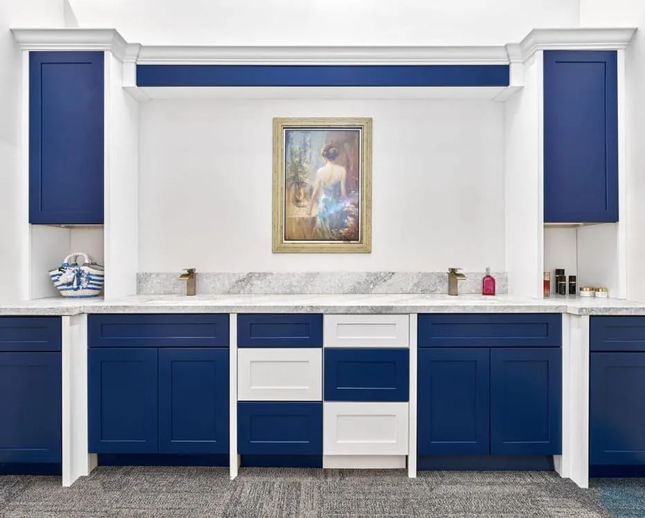 Navy-and-white showroom vanity with framed art