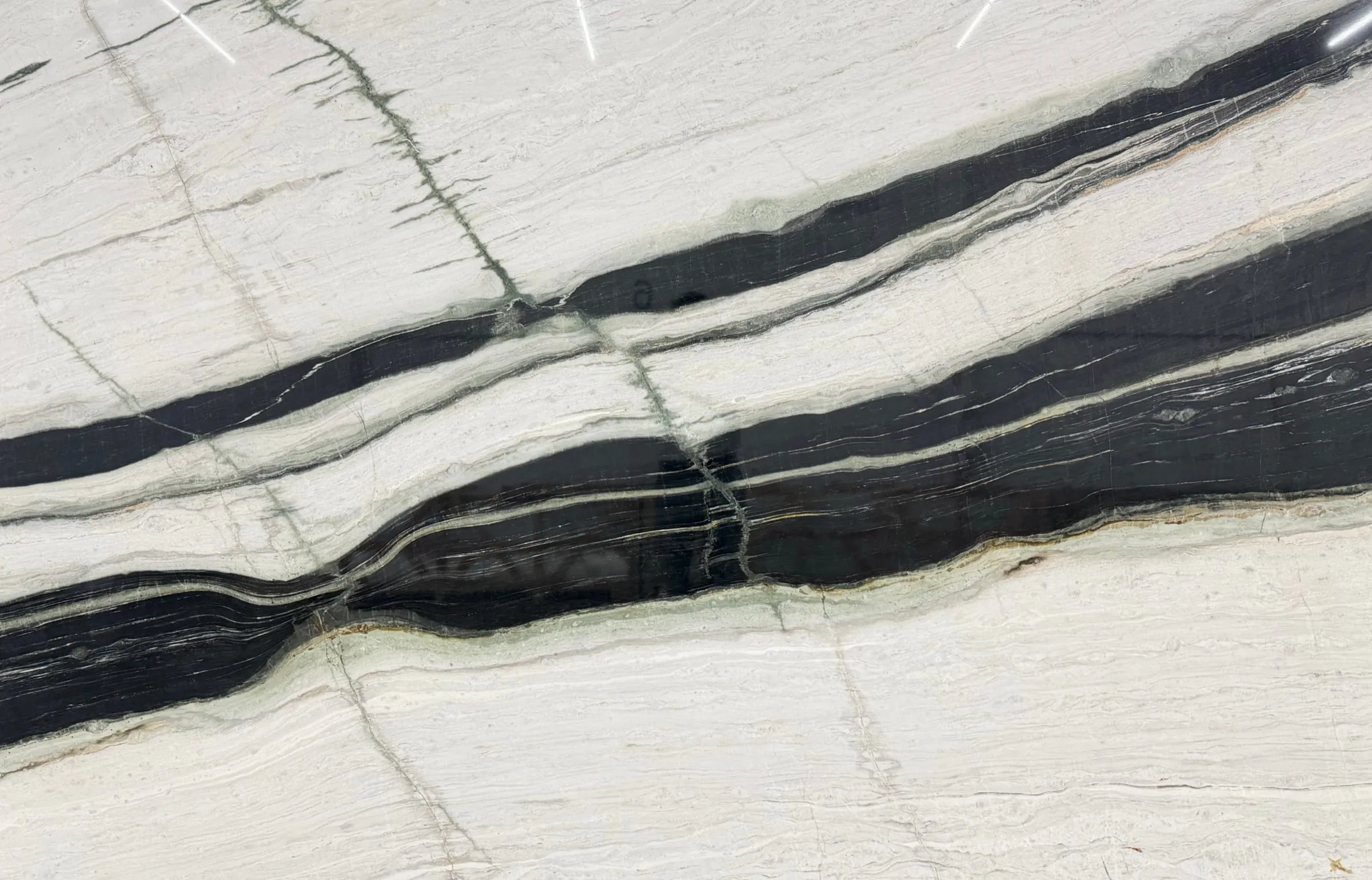 Amalfi quartzite slab, white with bold black diagonal bands and fine grey veins