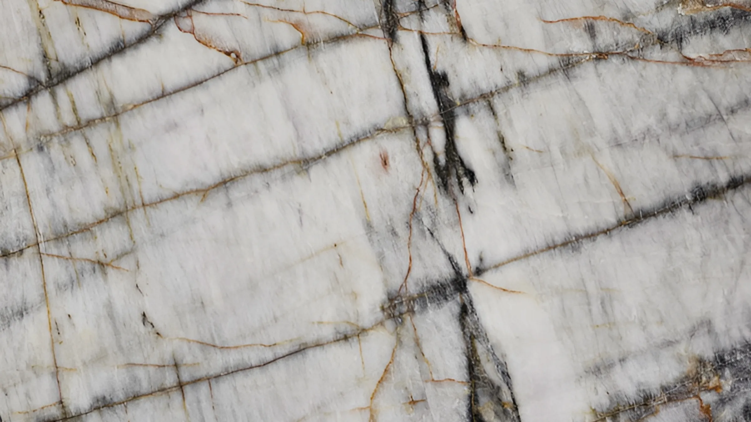 Crystallo Rare quartzite slab, translucent white with thin rust and charcoal veins