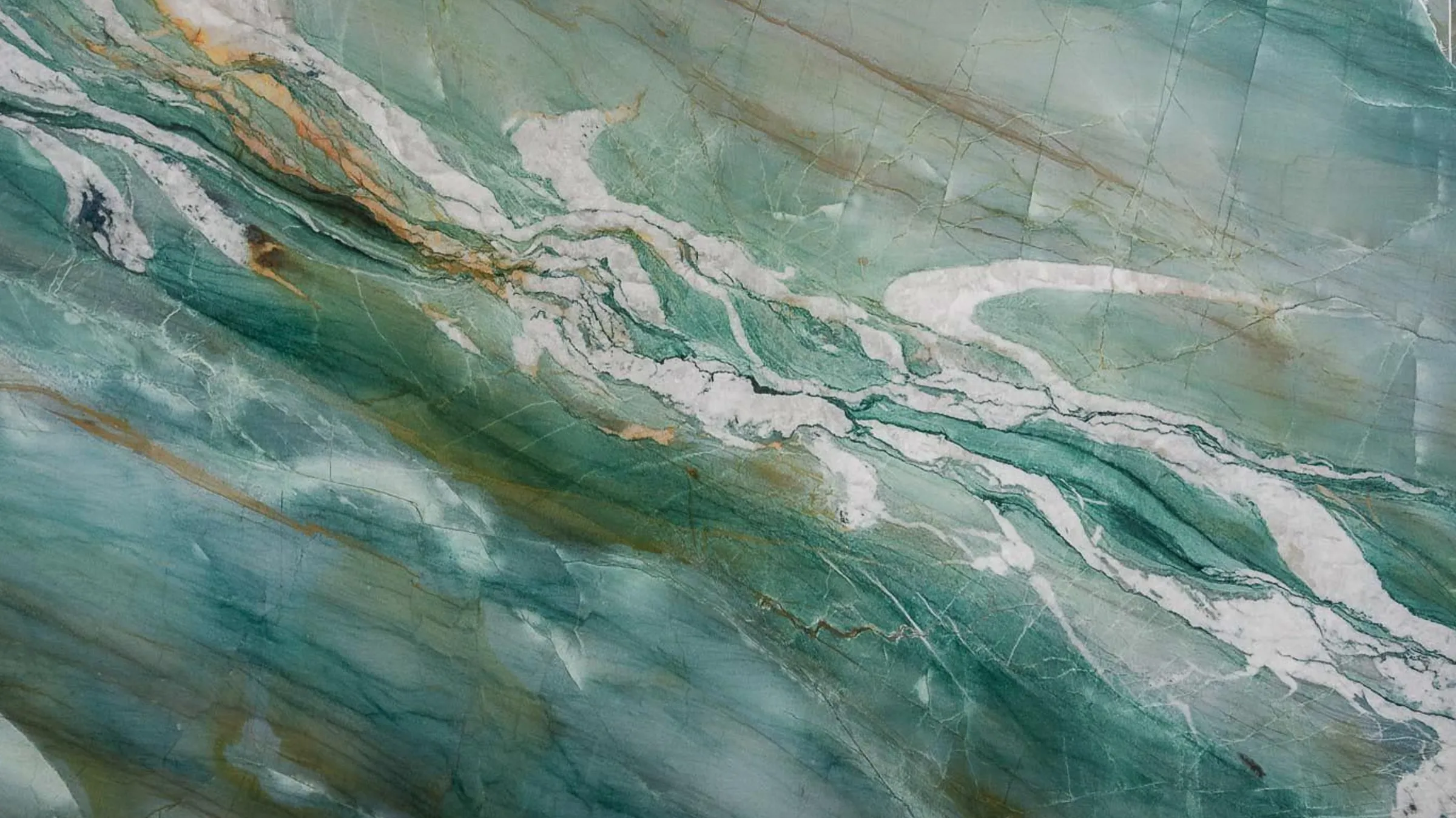 Mocamblu quartzite slab in sea green and teal with white veins and gold streaks