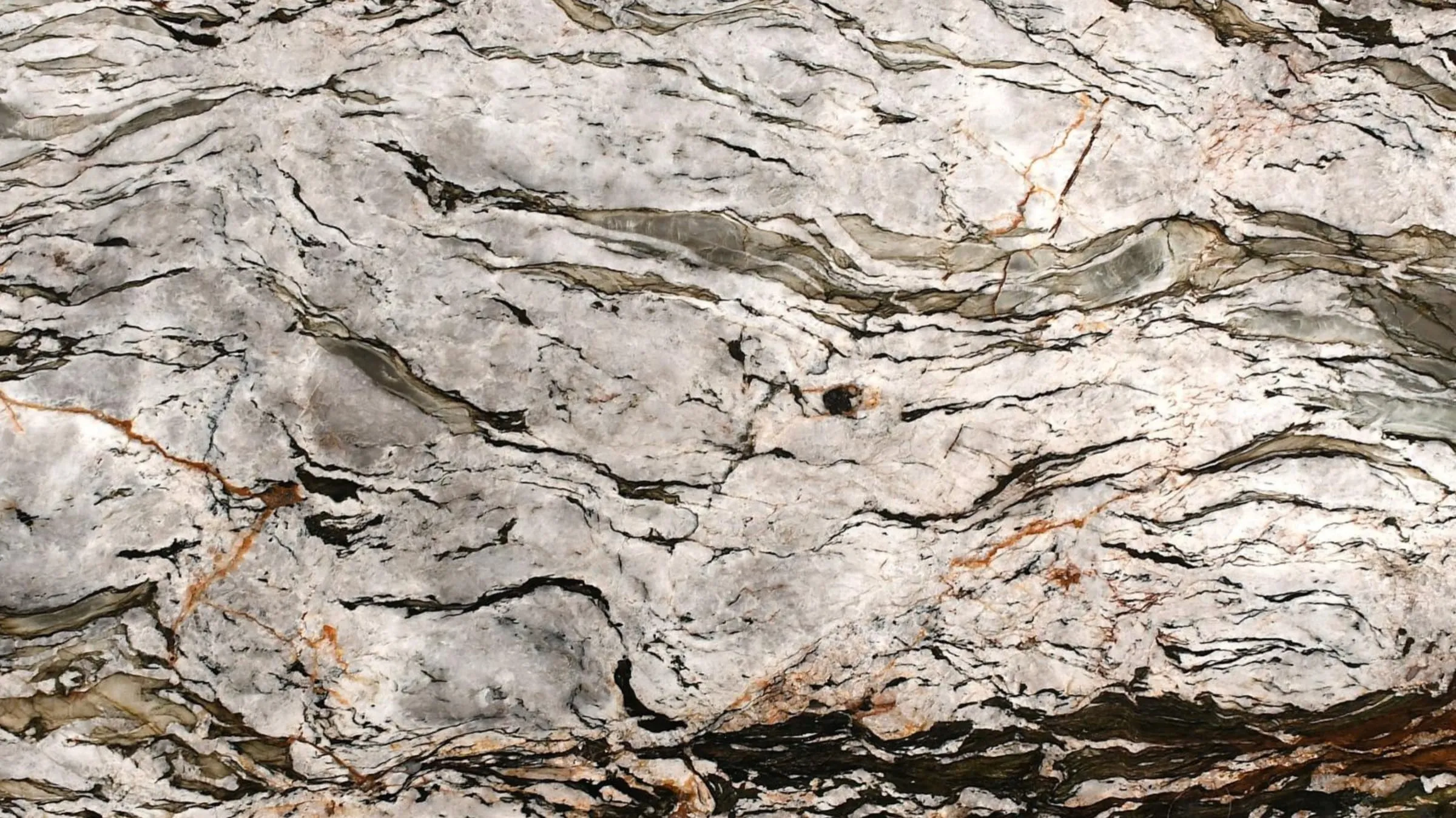 Tempest Crystal quartzite slab with a polished surface, pale white with black tracery and copper veins