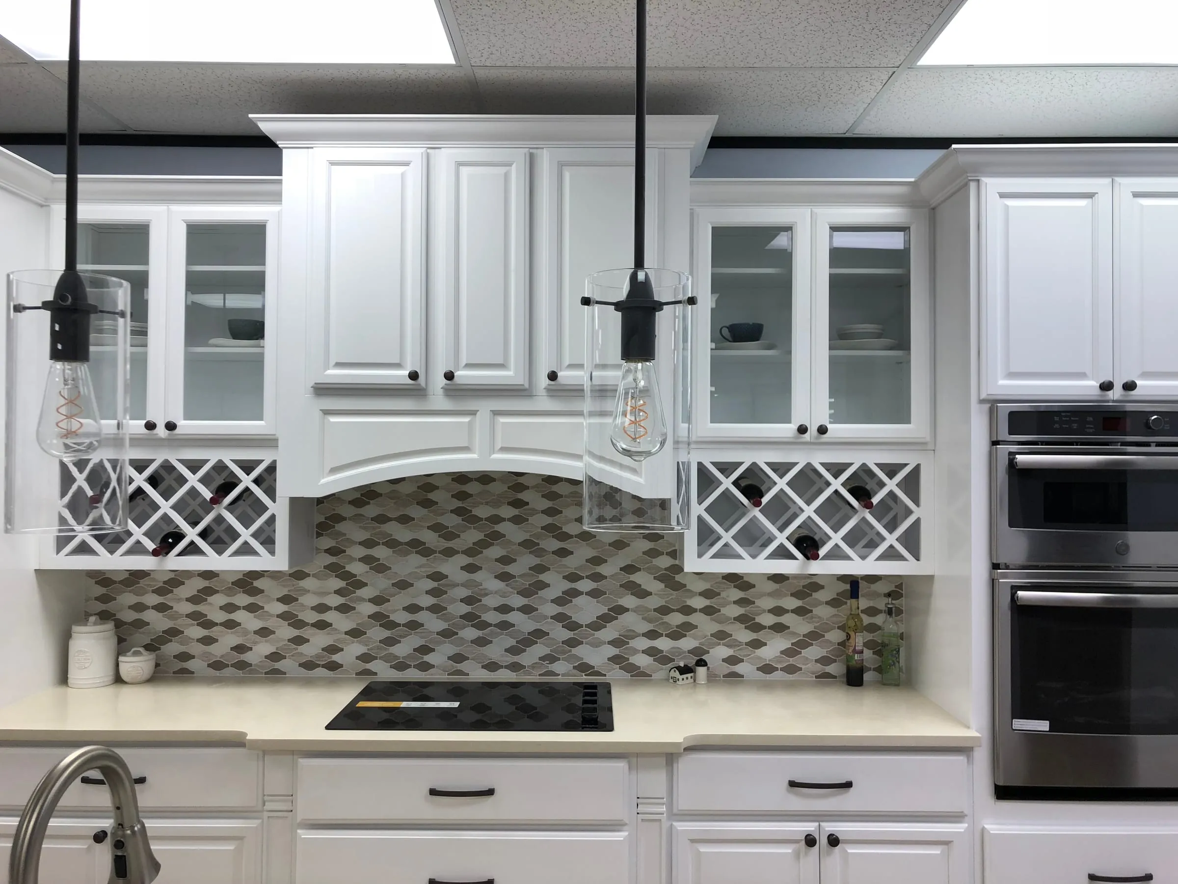 Classic White raised-panel uppers with an arched valance, wine lattice, and mosaic backsplash