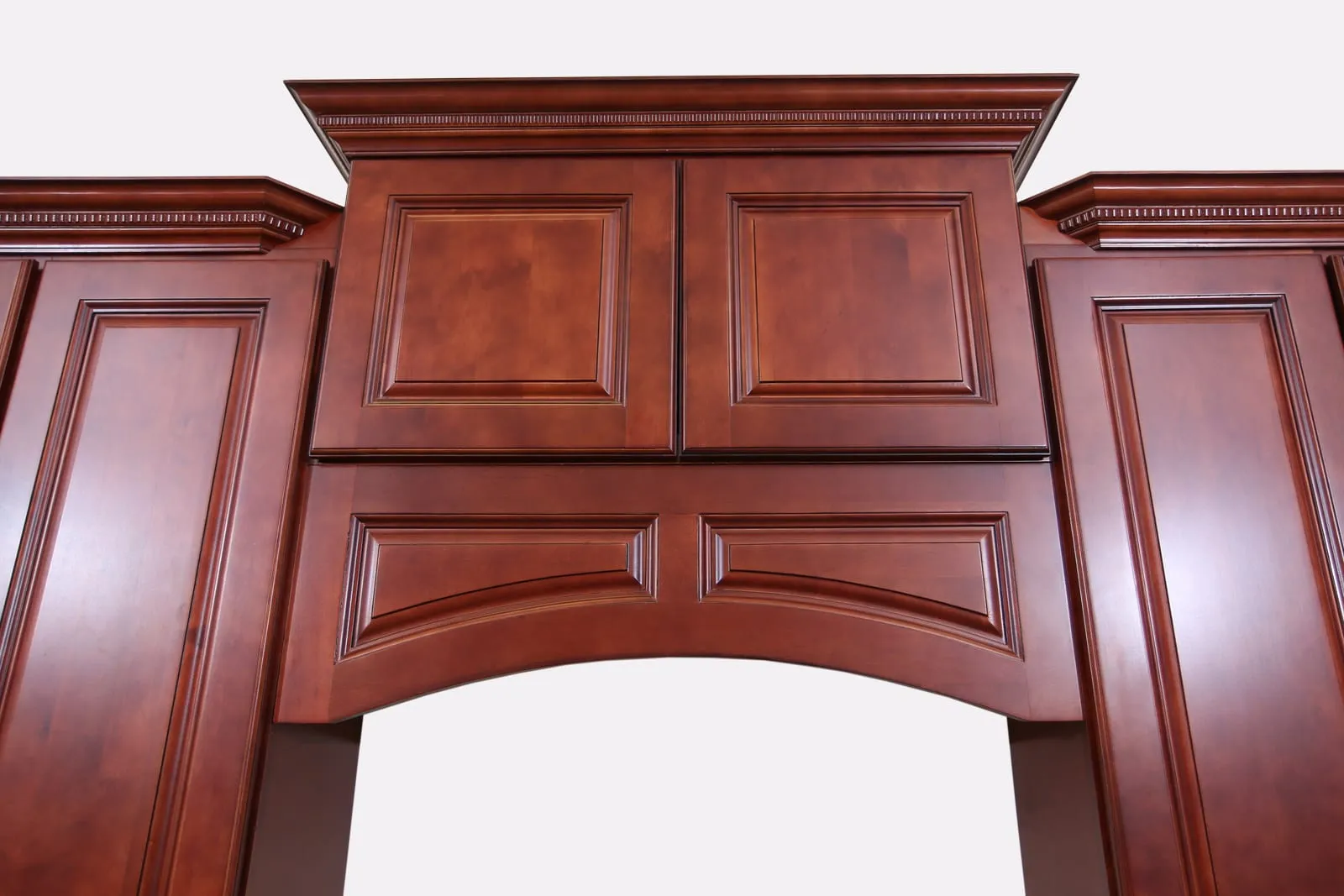 Dark Cherry arched valance detail over a range, with crown molding above