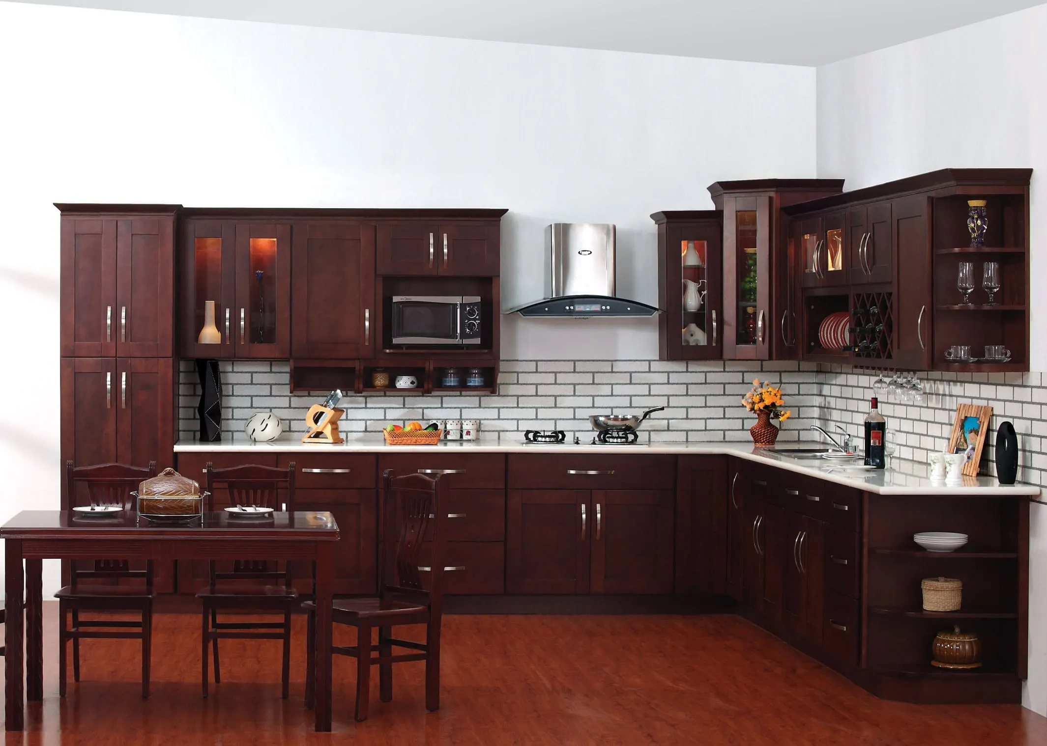 Espresso shaker kitchen with white subway backsplash, glass-front upper cabinets, and a small dining table