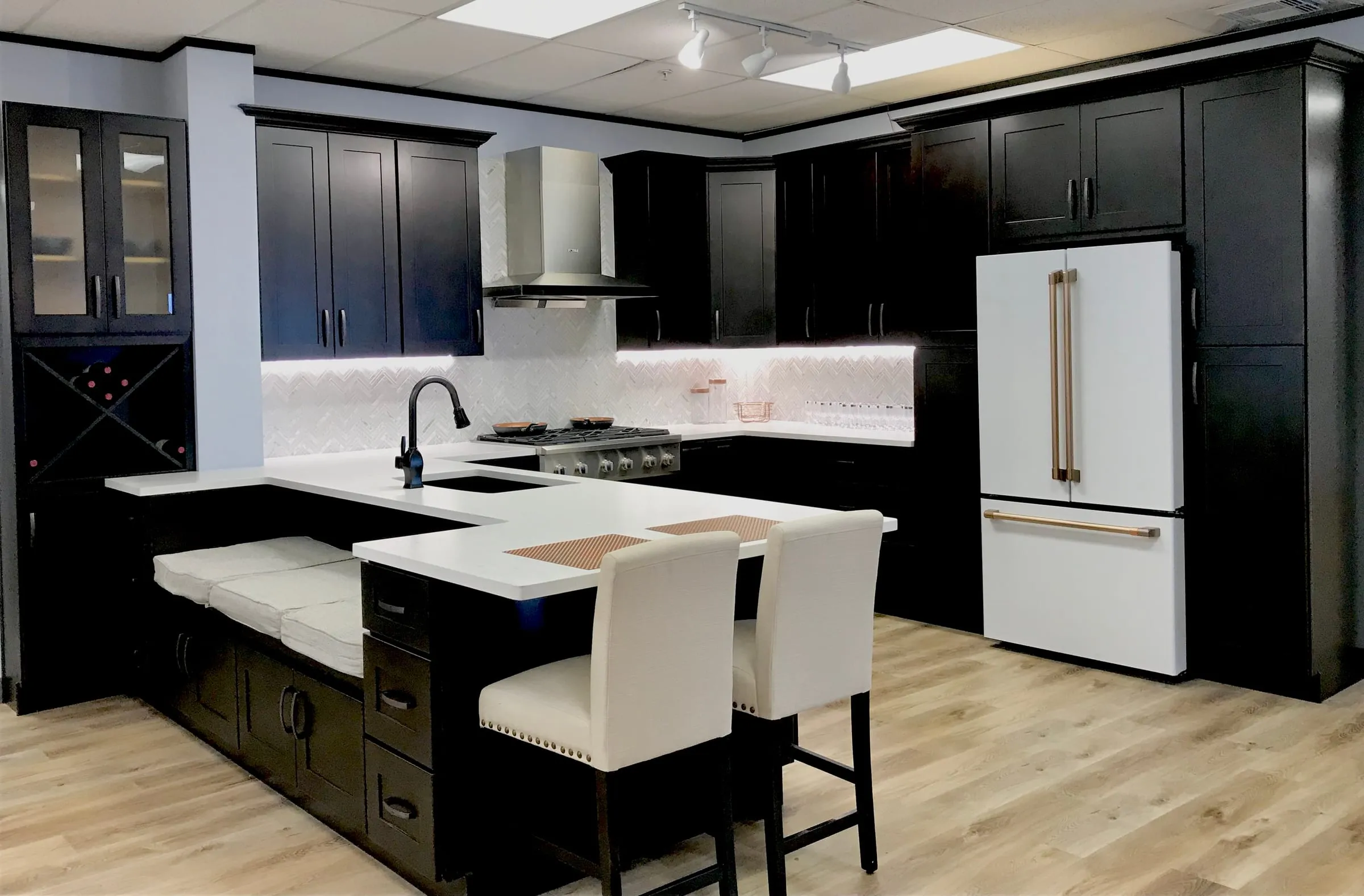 Java shaker kitchen with a white island top, wine rack, and a white refrigerator