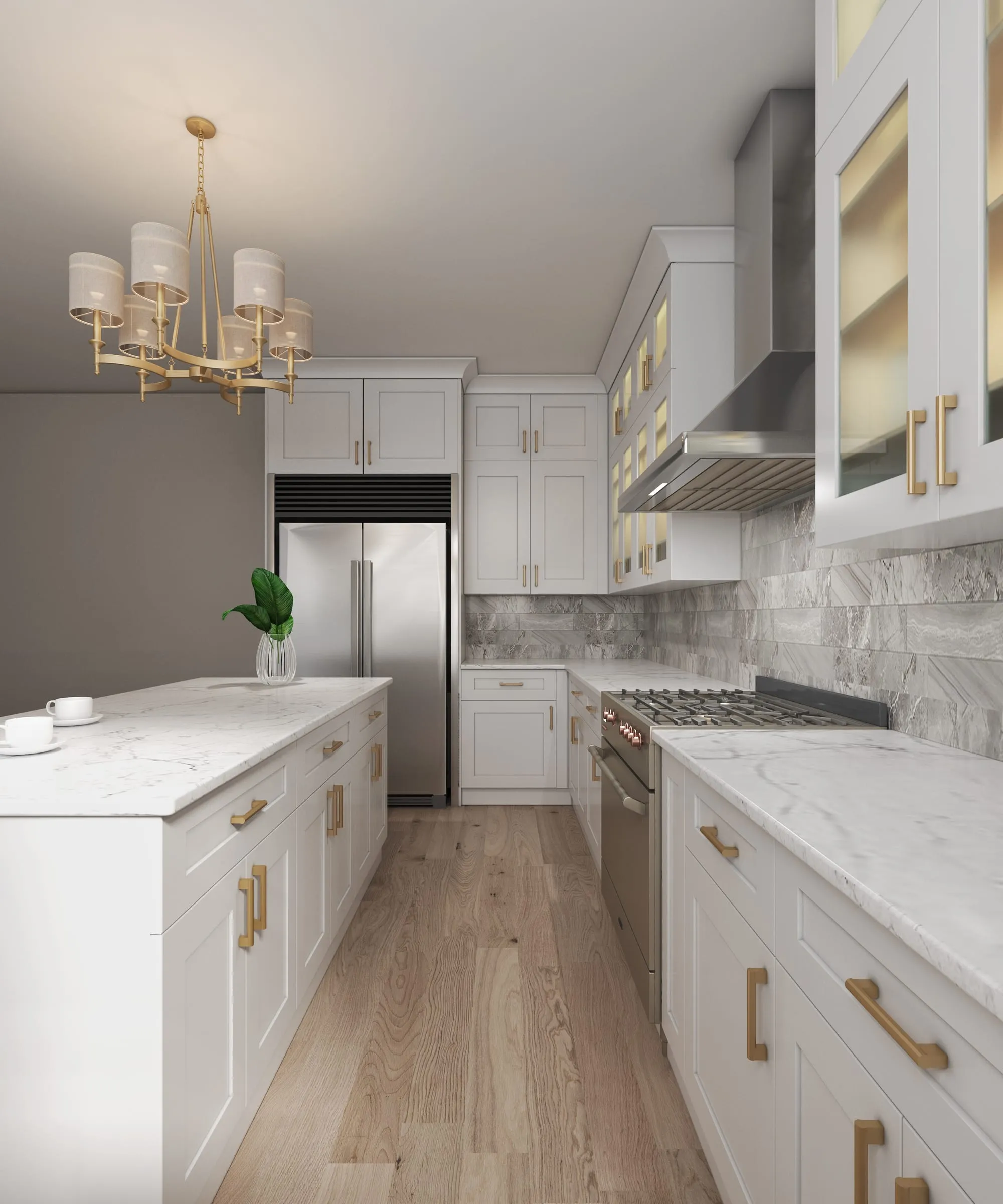 Galley kitchen in white shaker cabinets with marble counters and gold pulls