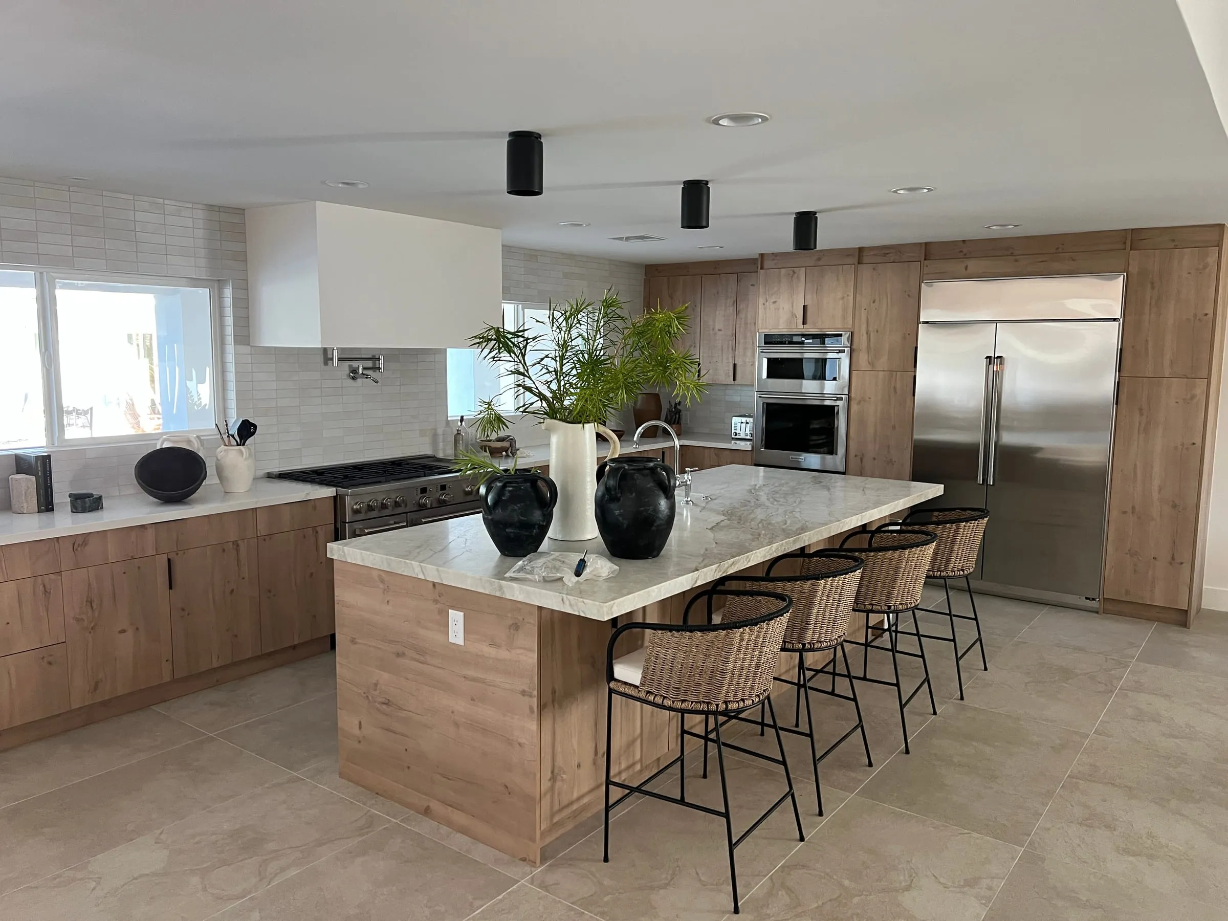 Rustic Oak kitchen with a large island, woven counter stools, and a stone island top