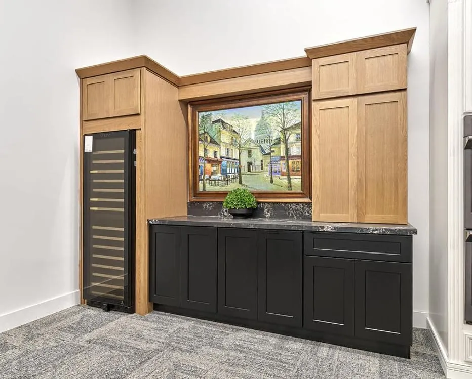 Light-oak showroom hutch with a wine cooler and framed art